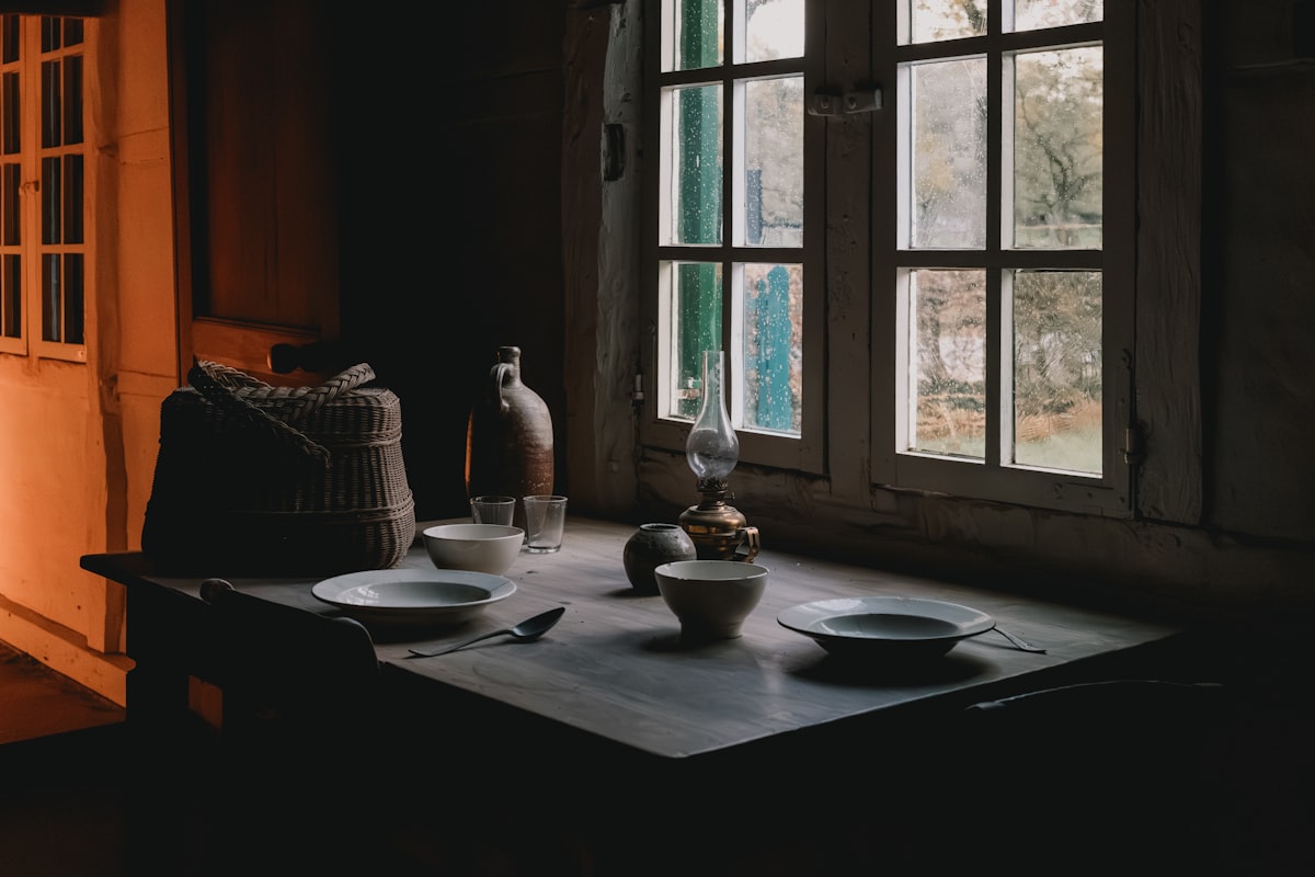 A farmcore-styled living room with distressed wood, iron accents, and linen textiles