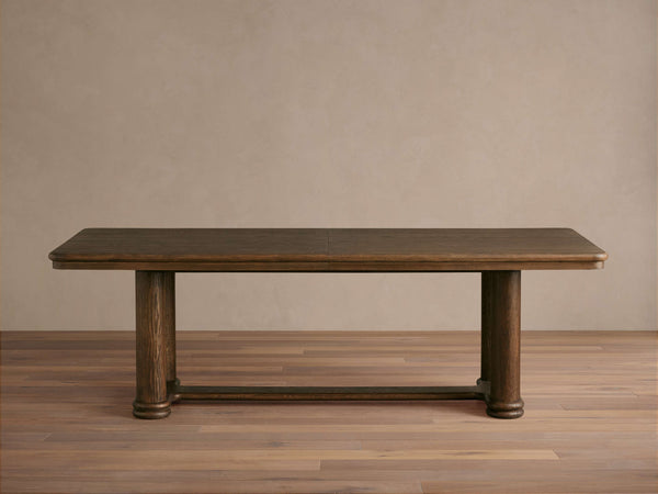 Dark oak column-leg dining table with hand-planed top and trestle base
